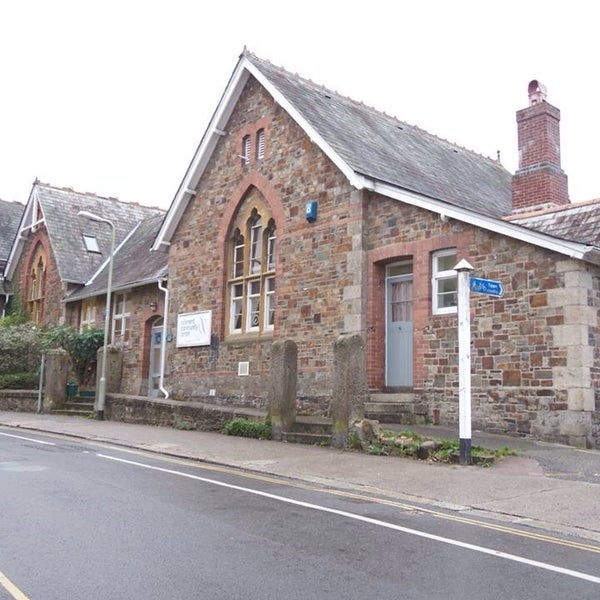 Ockment Centre - brick building with apex roof. Ramp and stepped access. Signpost.